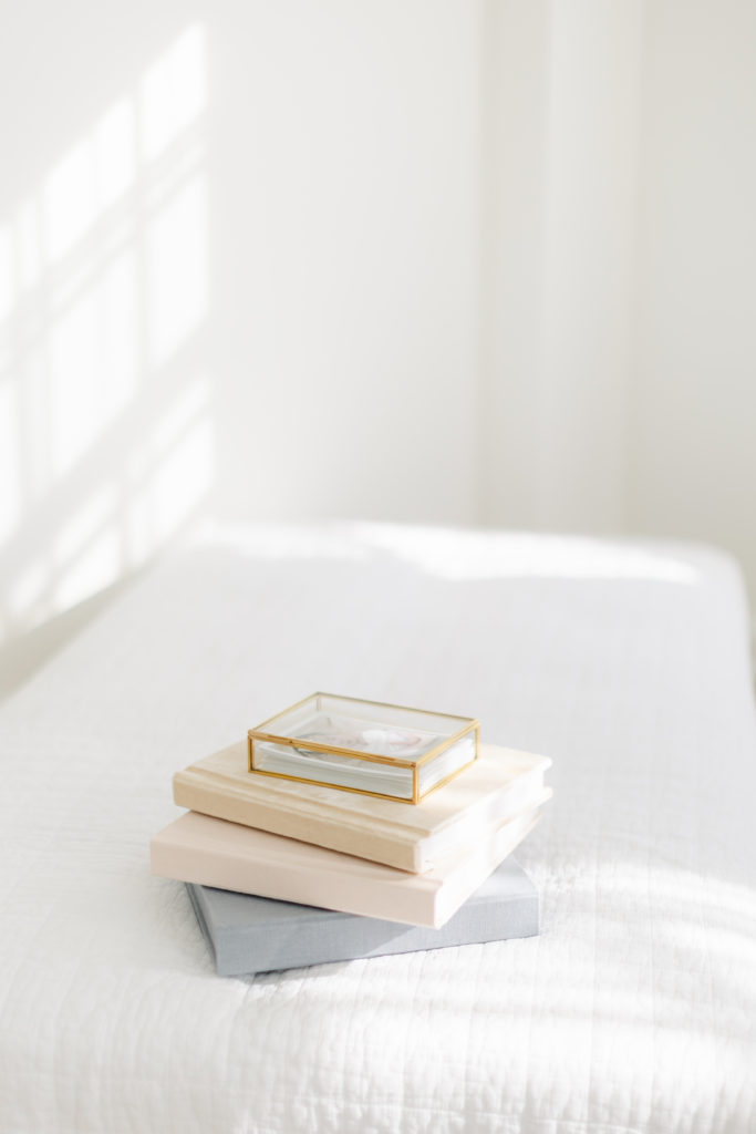 a stack of beautiful linen heirloom albums by Tara Federico Photography