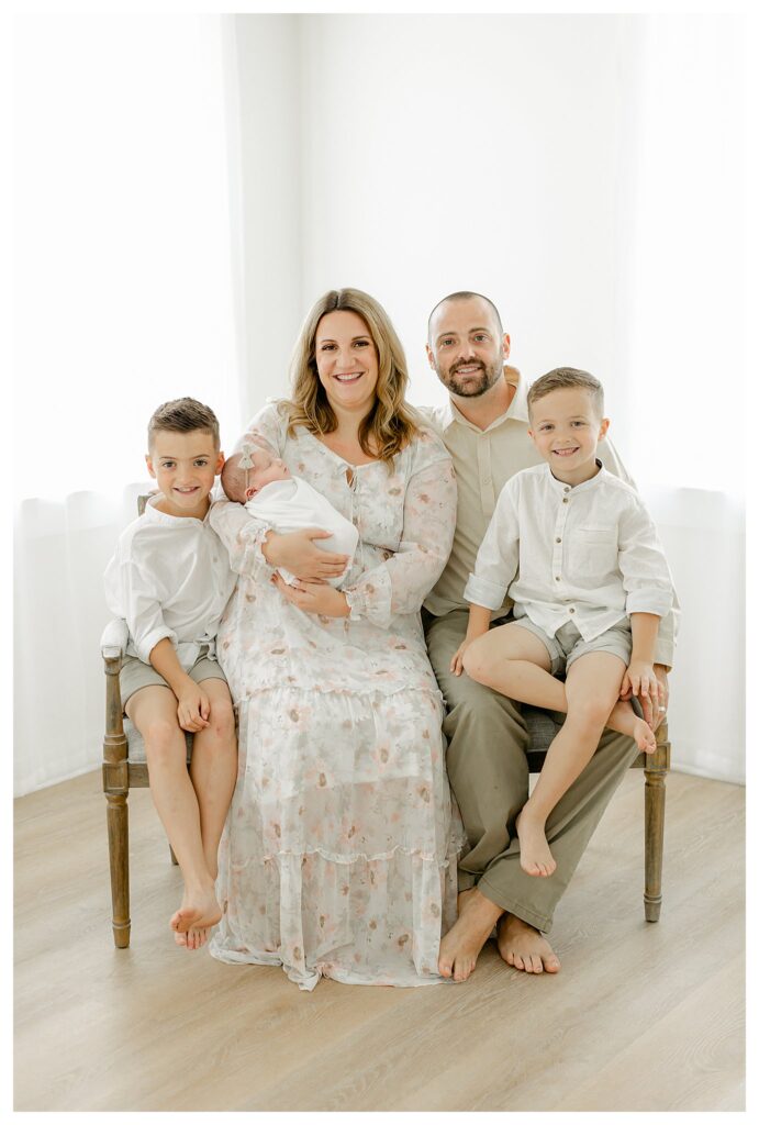 Family of 5 in a brightly lit South Jersey Studio having newborn portraits taken