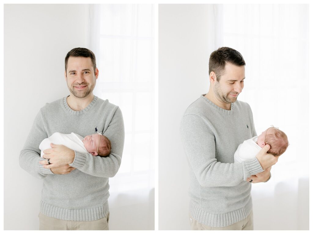Dad wearing a grey sweater holding his baby girl during their Philadelphia Newborn Session with Tara Federico Photography