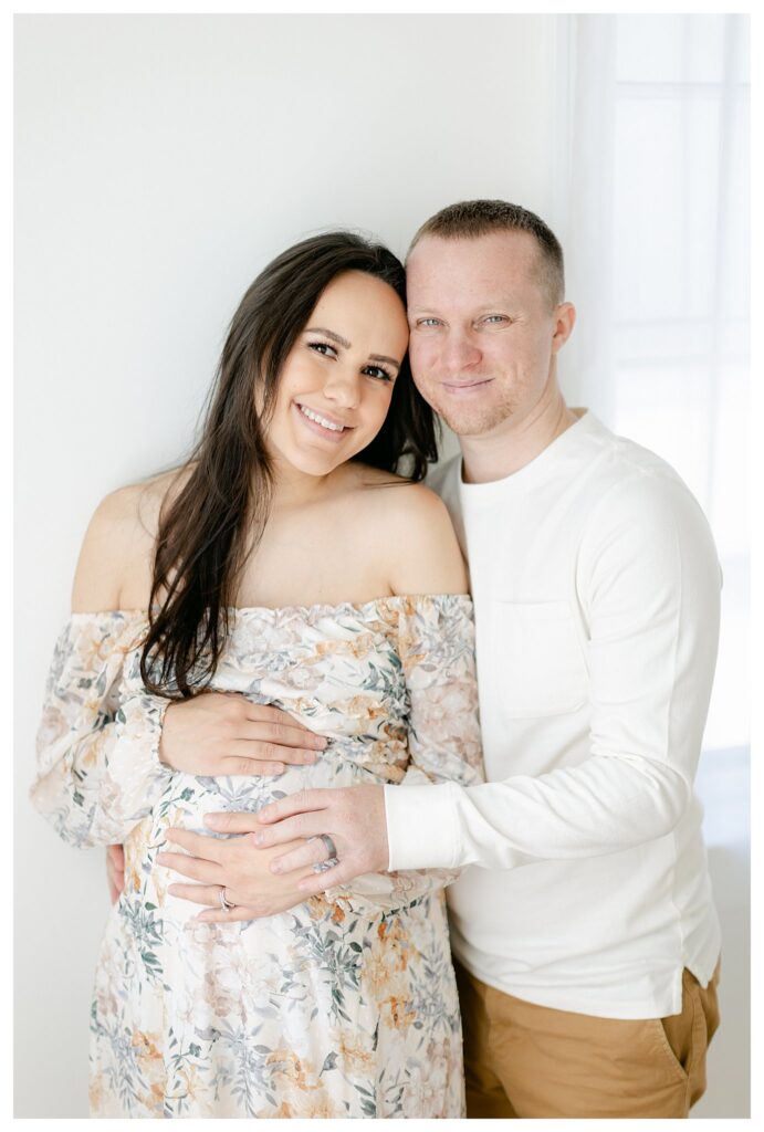a husband and wife smiling happily during their maternity photos in Charleston with Tara Federico Photography