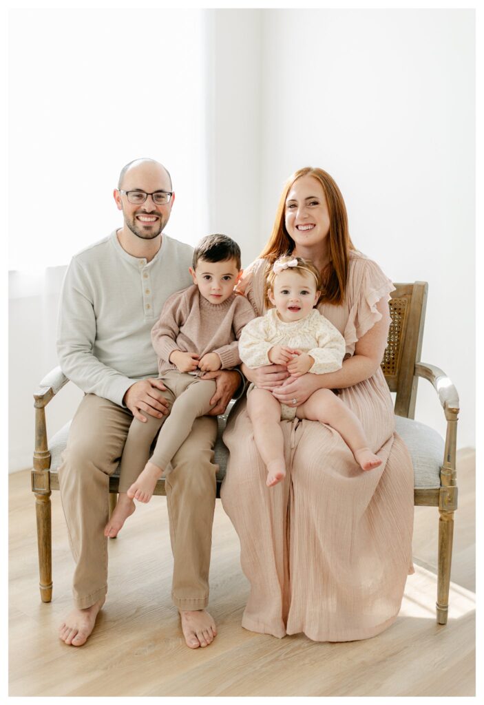 family of 4 in a brightly lit studio photographed by Tara Federico