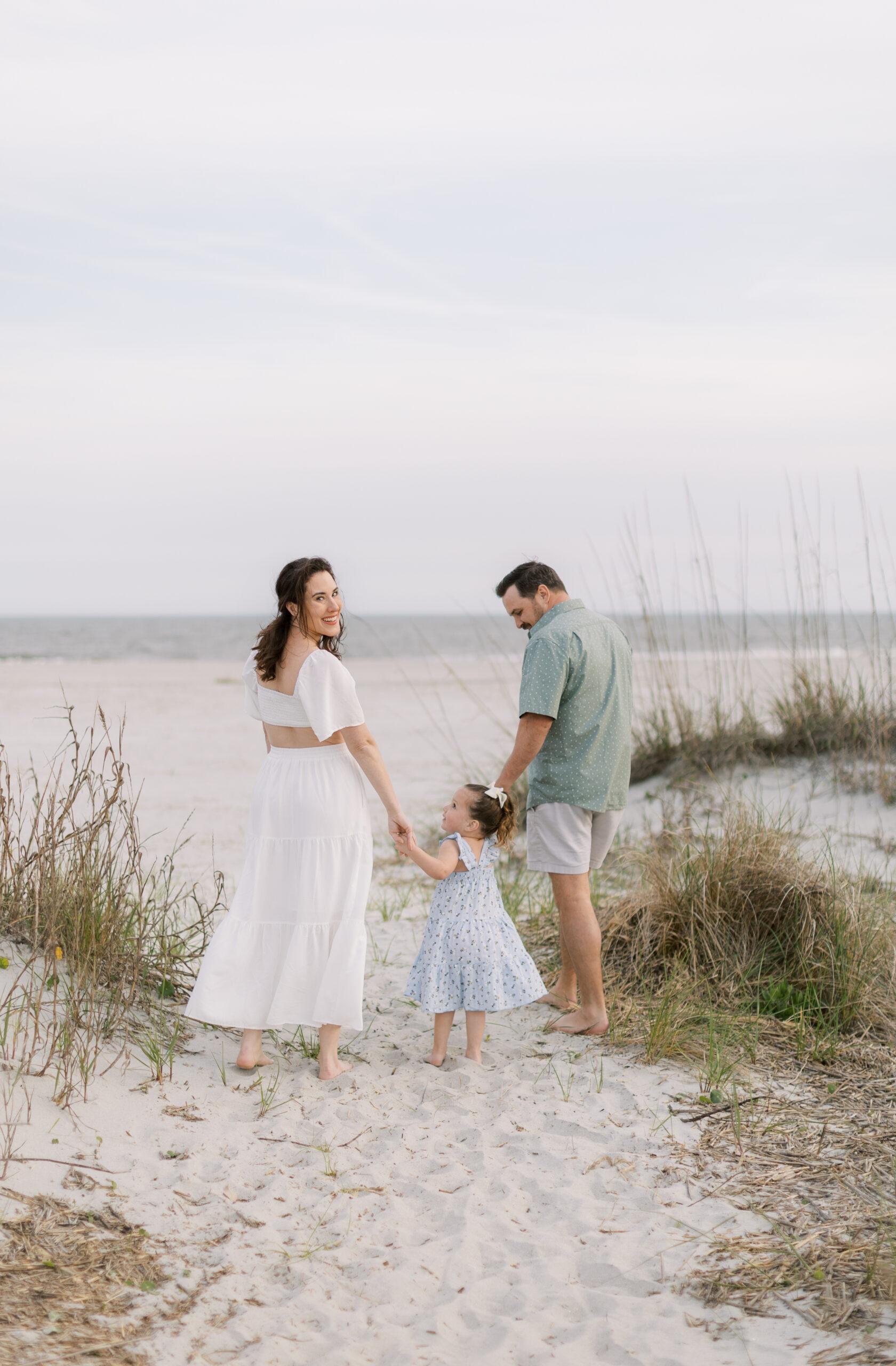 Mother in a flowing dress with her family, showing what to wear for a family session at Isle of Palms