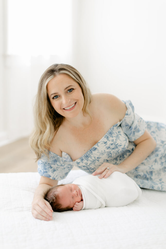 Tender moment of mother cradling her newborn baby in a Charleston photography session.