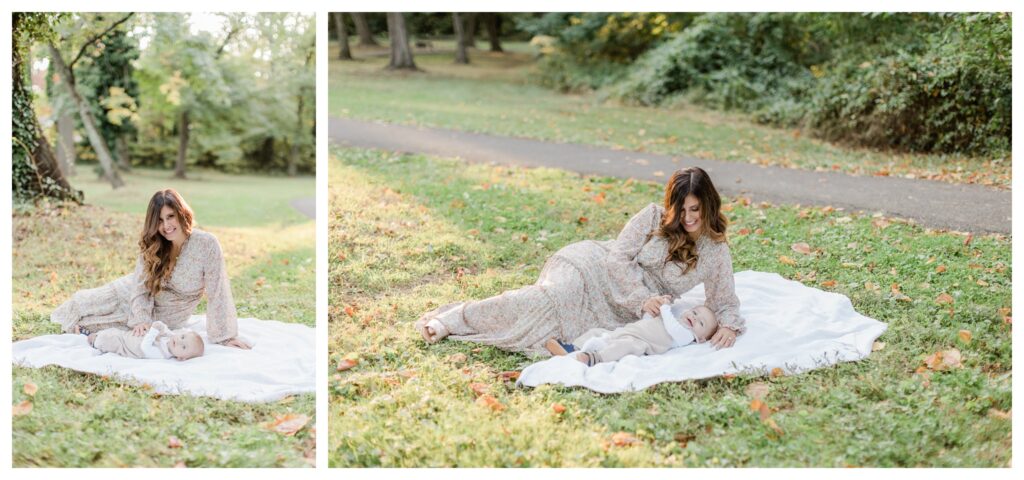 Candid fall family portraits in Charleston park with mom laughing with infant, surrounded by vibrant autumn colors.